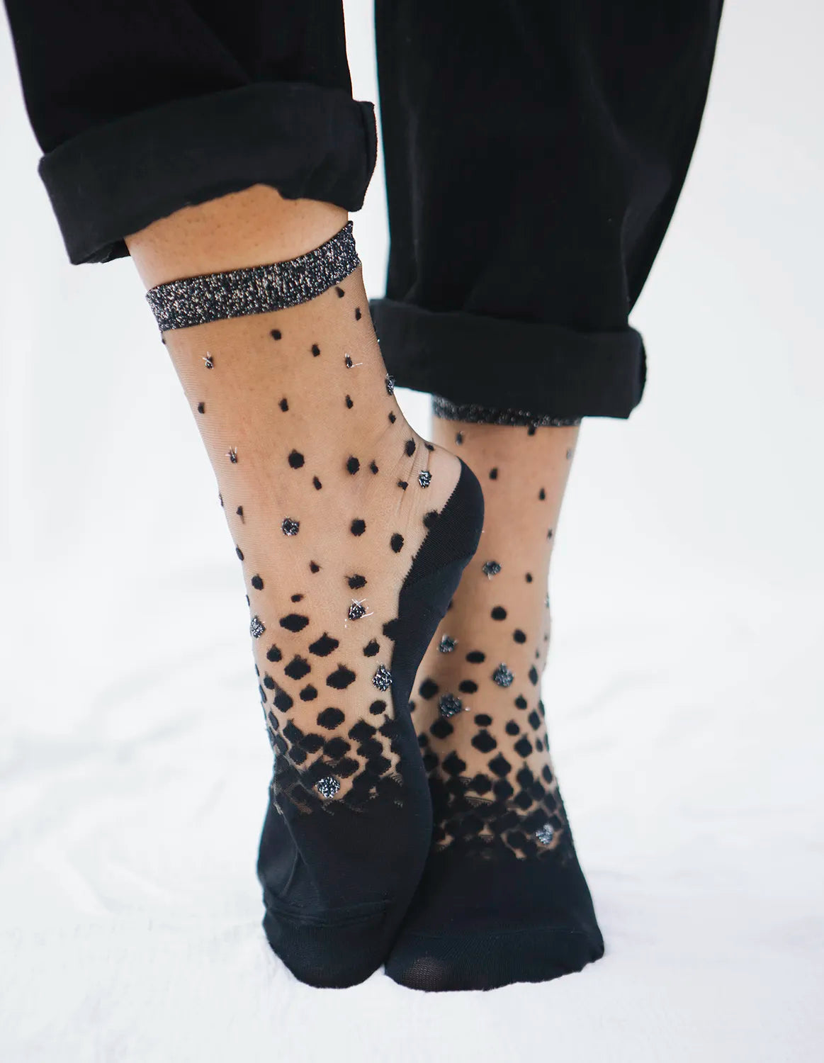 Zoom de la paire de chaussettes transparentes à paillettes argentées Nakameguro silver Atelier St Eustache portées par une mannequin